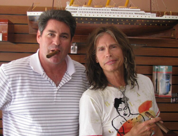 Steven Tyler in shop with owner