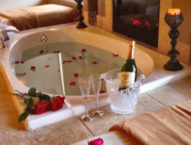 soaking tub with flowers and champagne