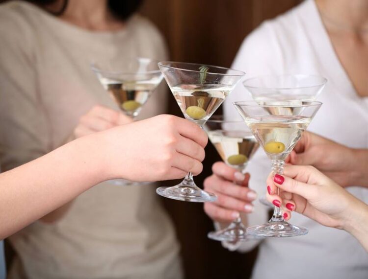 people holding martinis