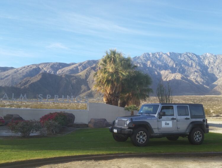 jeep in front of palm springs sign