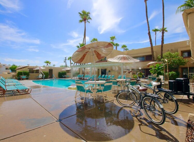 Desert Vacation Villas pool, lounge seating, and bikes