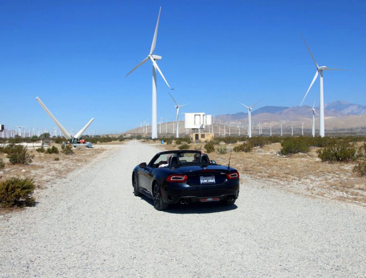 car driving near wind turbines