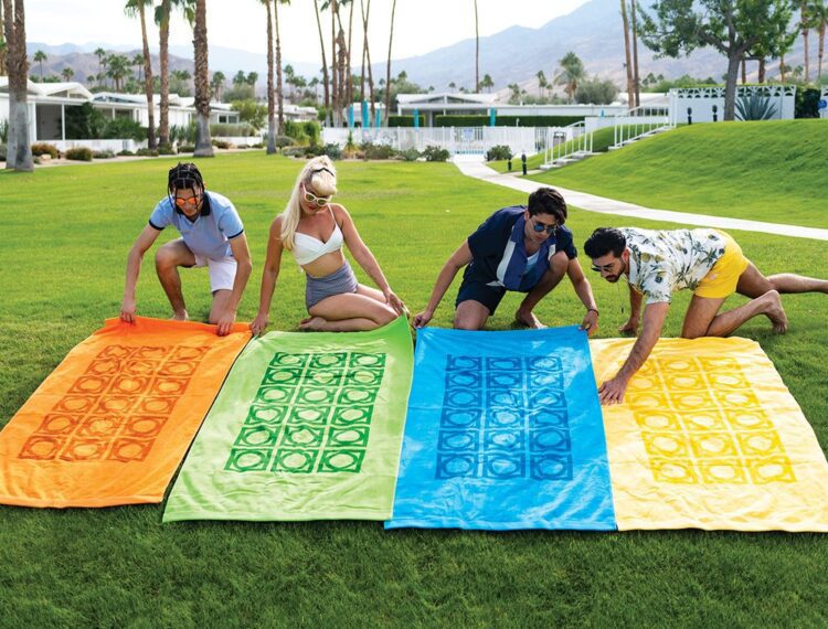 people on lawn laying out beach towels