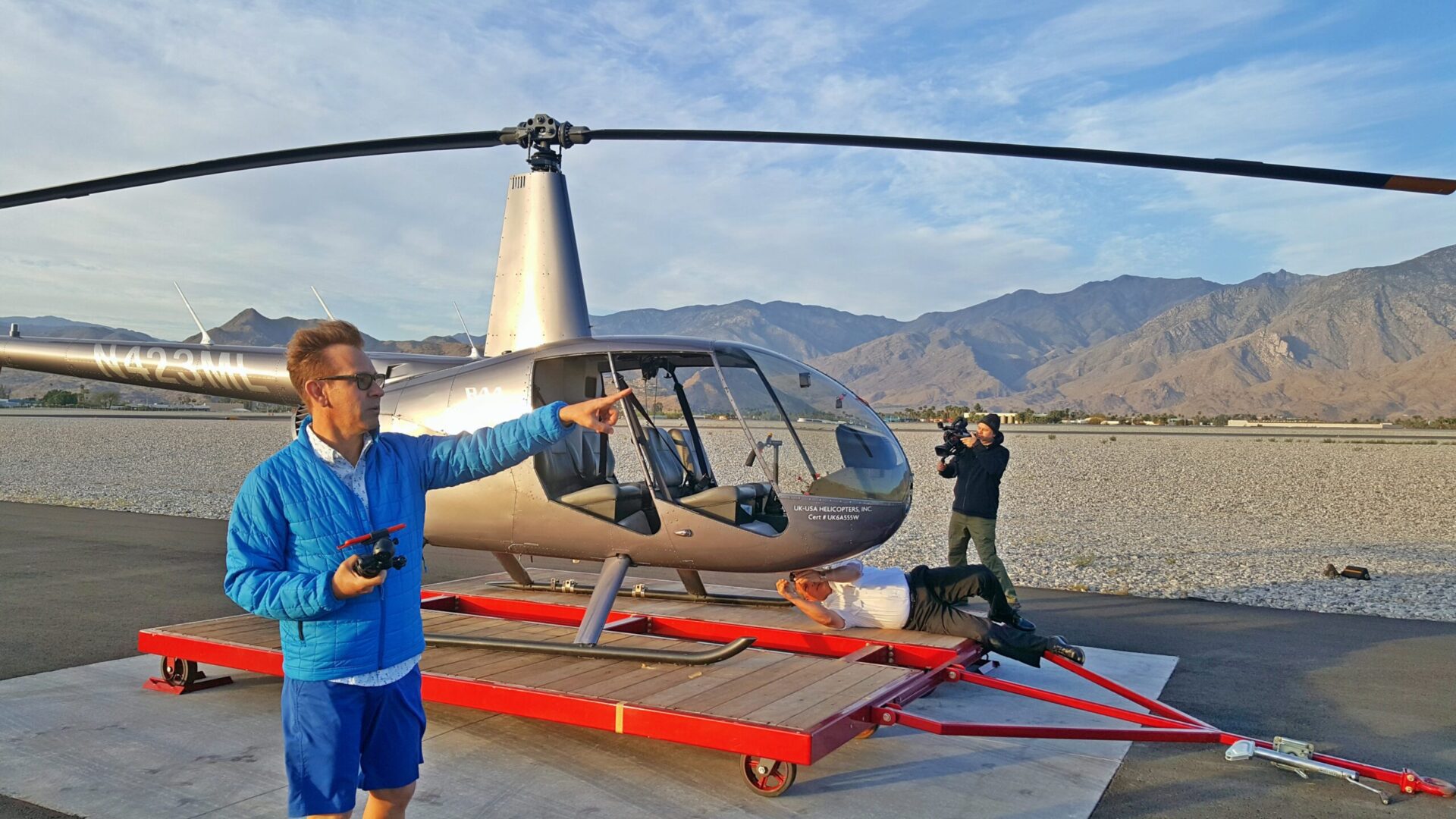 Film crew preparing shot with helicopter