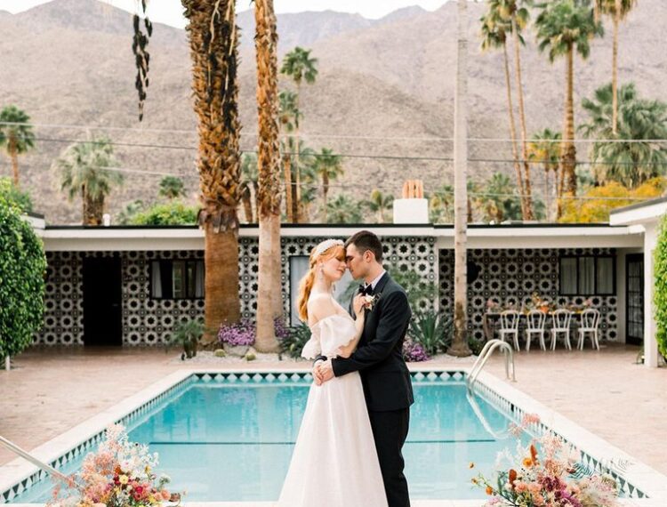 bride and groom in front of pool