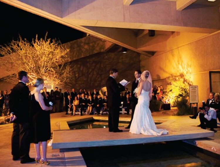 bride and groom on outdoor atrium bridge