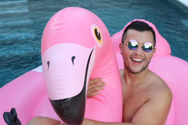 an with inflatable flamingo in swimming pool